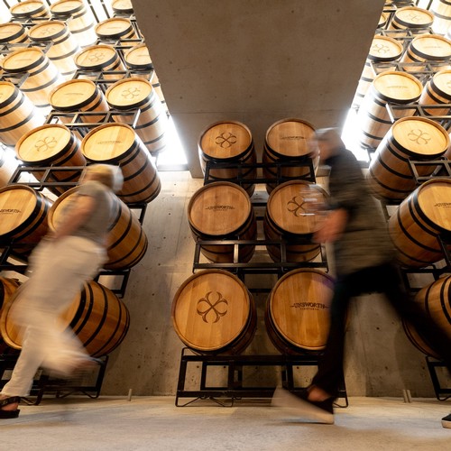 Unsworth Vineyards estate tour in barrel cellar with premium wines.